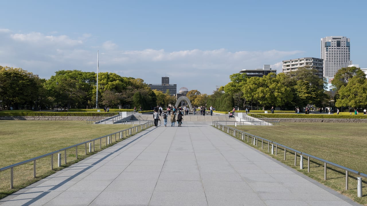 The Cenotaph in Hiroshima Peace Memorial Park, framing the A-Bomb Dome beyond