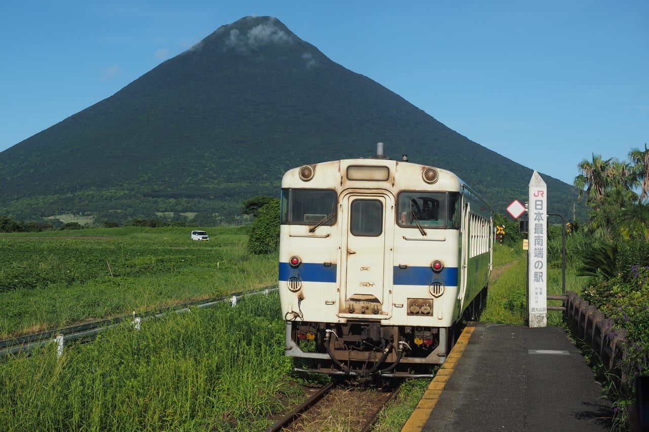 JR 西大山駅一帶,普通列車駛過、背景是對稱錐形的開聞岳
